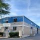 Picture of outdoor building with trees and sky featuring ControlOmatics New Facility