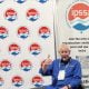 Picture of Mike Denham IPSSA President in front of IPSSA banner - IPSSA Donates $10,000 to California Fire Relief Fund