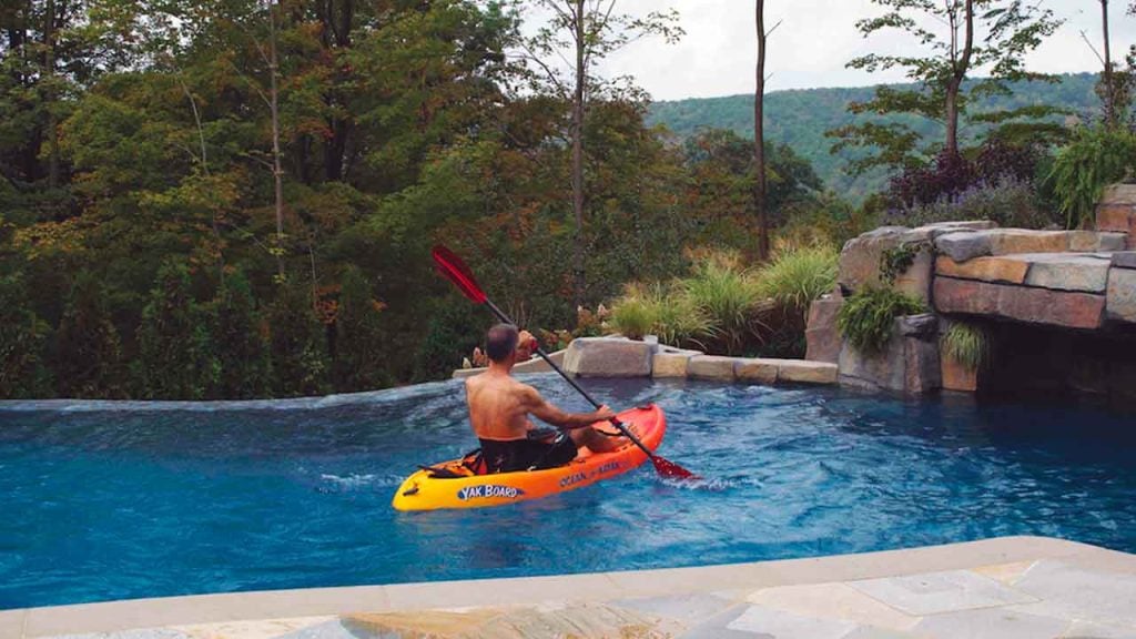 ADVENTURE POOL: Pool owner using his Riverflow pump to generate swim current for kayaking in his pool.