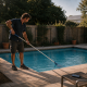pool technician cleaning a swimming pool